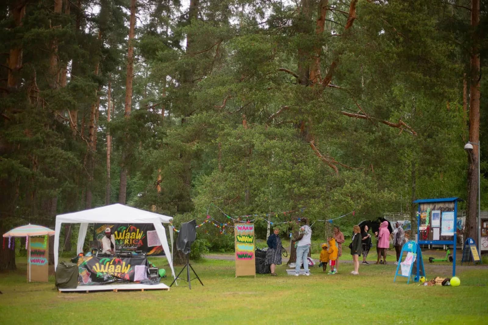 The WaawAfrica tent and banners set up in a pine forest park